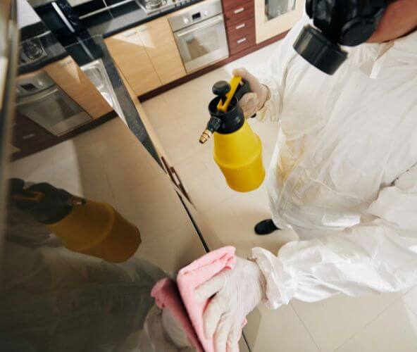 Specialist in hazmat suit performing blood cleanup in Anaheim, CA