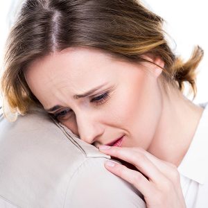 Woman crying on shoulder after suicide clean up in Los Angeles, CA 